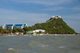 Thailand: Heavy seas smash against Prachuap Khiri Khan's promenade with Khao Chong Krajok (Mirror Mountain) and Wat Thammikaram in the background